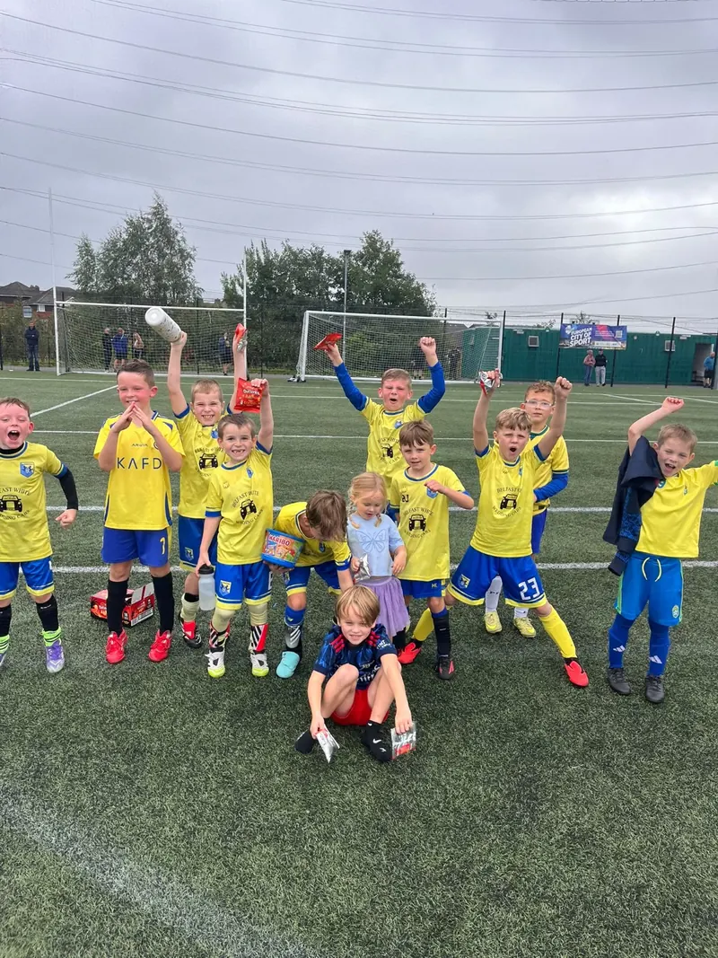 A squad cheering together on a 3G pitch